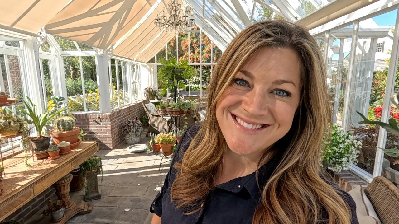 Laura smiling in the greenhouse