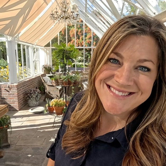 Laura smiling in the greenhouse