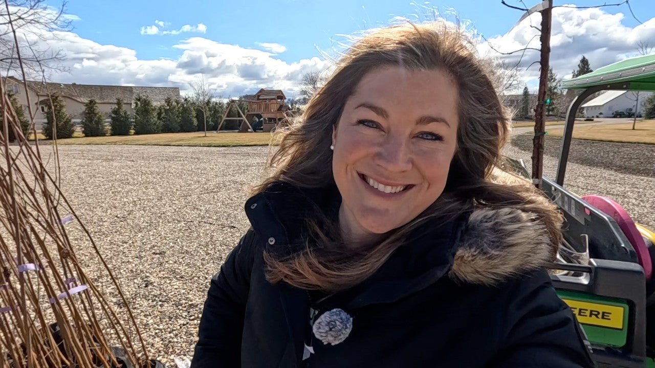 Laura smiling under the sun at her yard