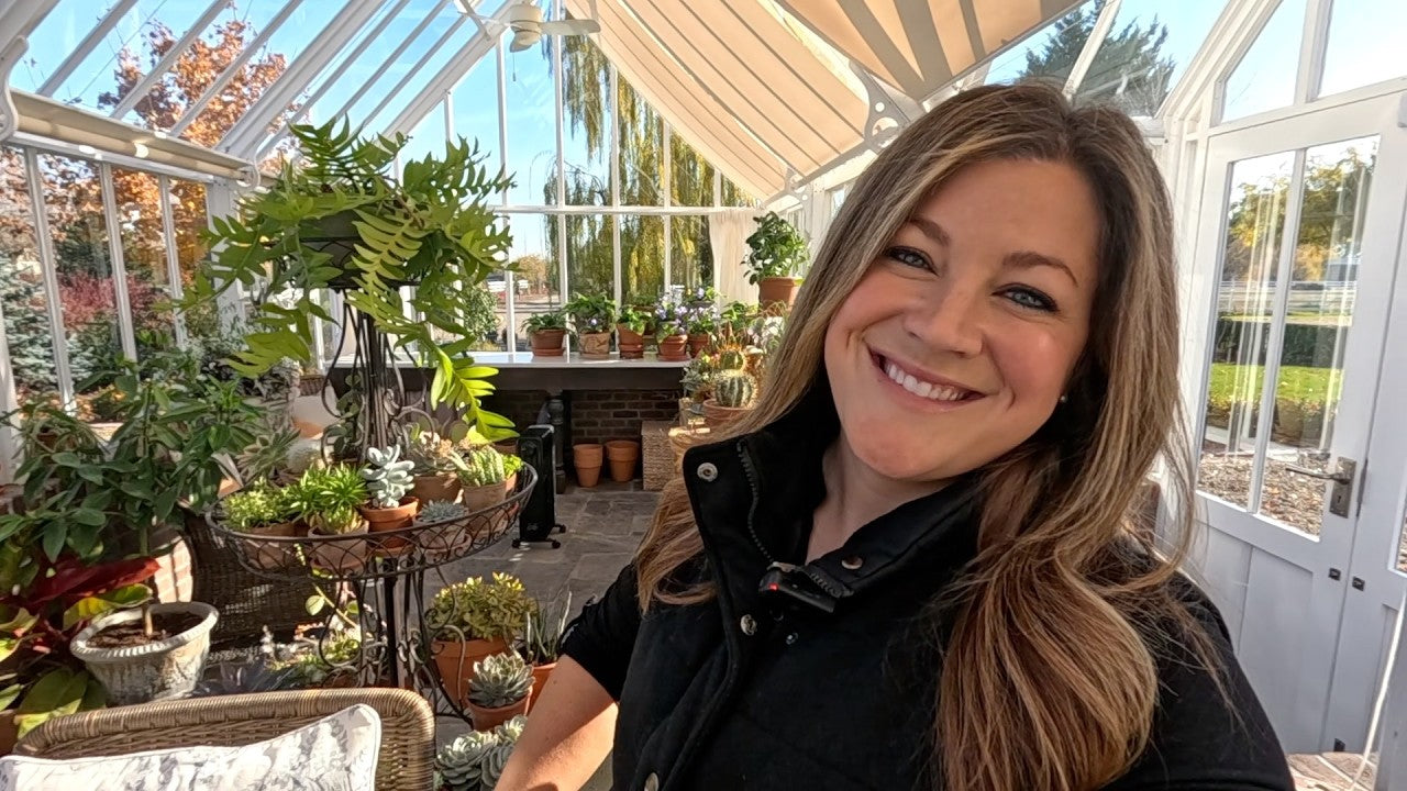 Lauras smiling in her greenhouse garden