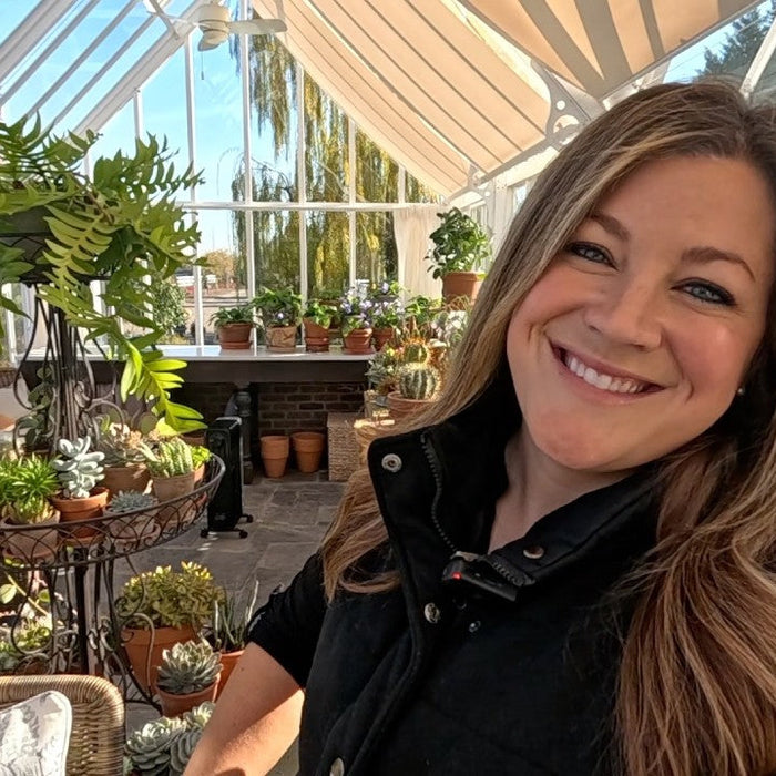 Lauras smiling in her greenhouse garden