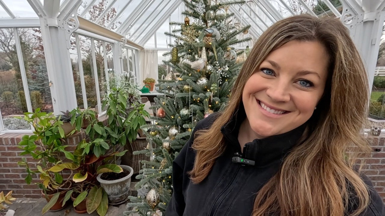 Laura smiling behind her christmas tree