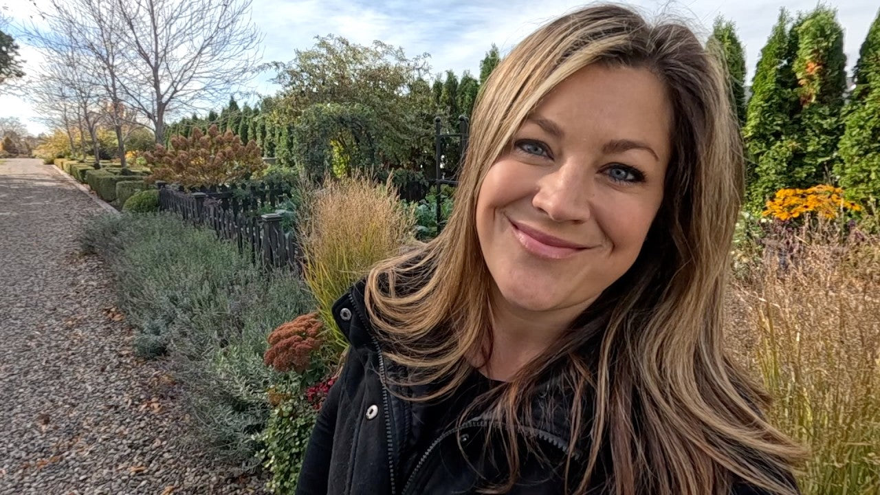 laura smiling behind her garden