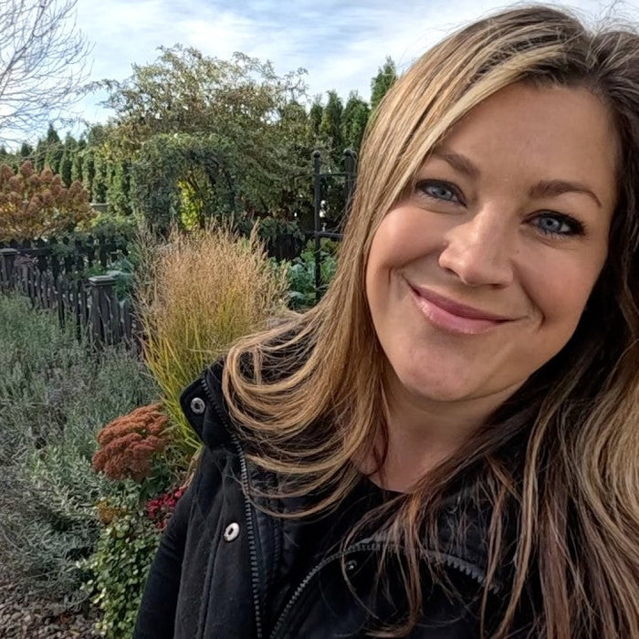 laura smiling behind her garden