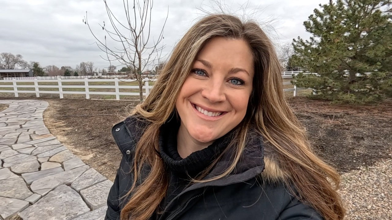 Laura smiling behind an entryway in winter