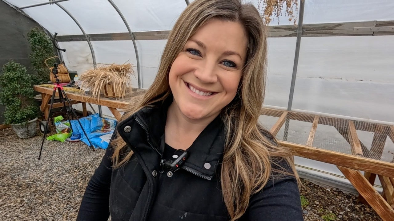 Laura smiling with some wood tools in the back