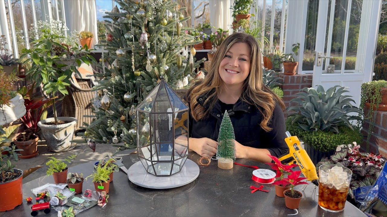 Laura smiling in her green garden with tools to build a terrarium