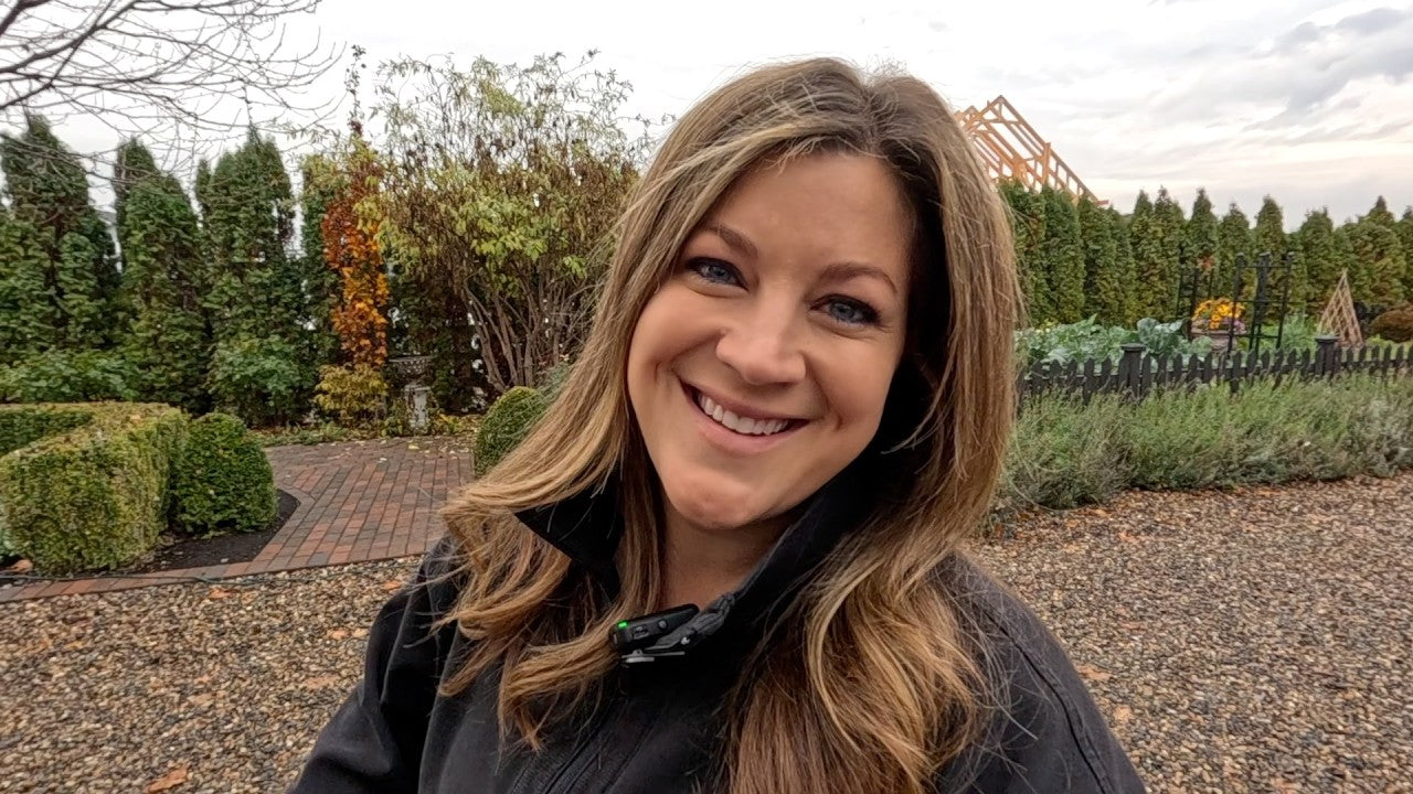 Laura smiling behind the garden