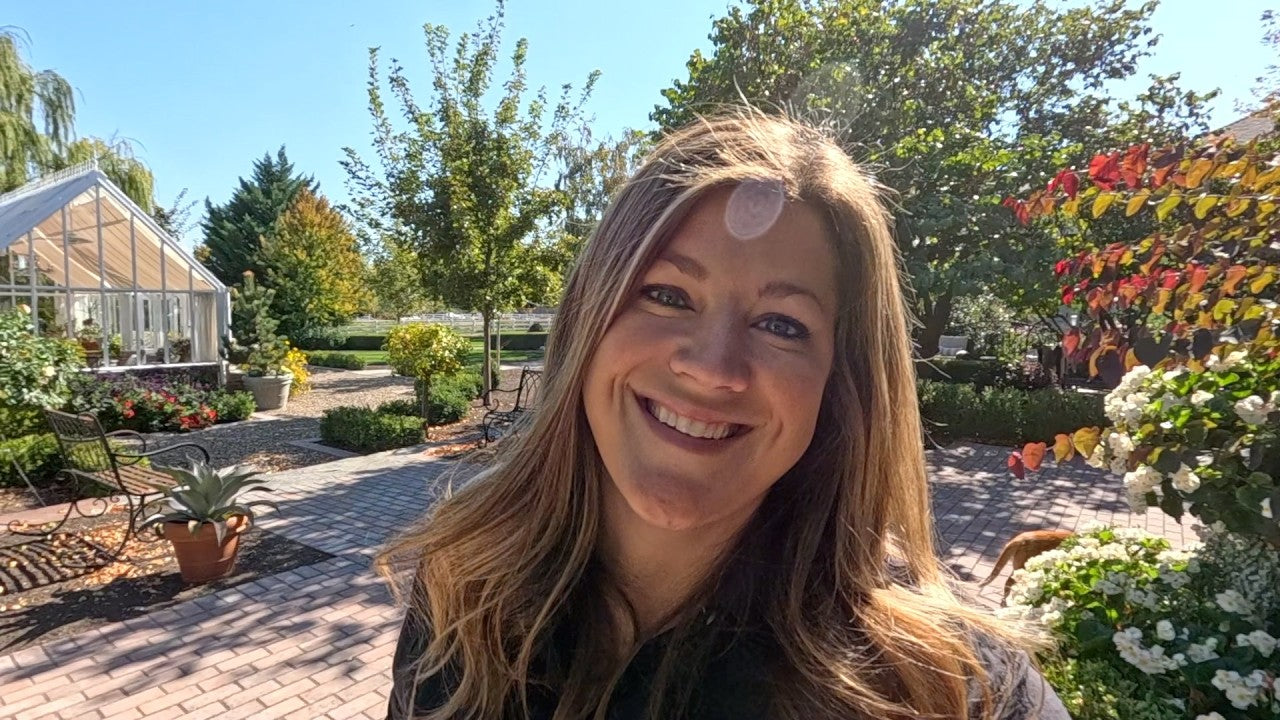 Laura smiling in her garden