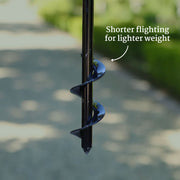 Garden auger with text indicating 'Shorter fluting for lighter weight' on a blurred outdoor background.