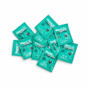 Ten green FloraLife Flower Food packets are arranged in a scattered pile on a white background. Designed as vase water conditioners, each packet features white text and a black flower icon on the front, helping to extend the life of your fresh arrangements.