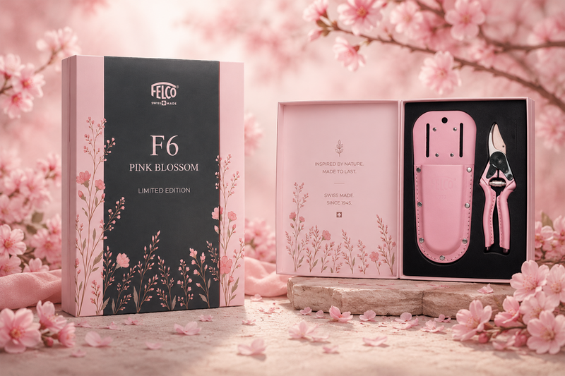 A light pink FELCO 6 Pink Blossom pruning shear and matching holster displayed inside an open gift box decorated with floral illustrations.