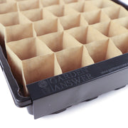 Black plastic seed-starting trays filled with paper grid inserts and Garden Answer Paper Pot Opening Clips (Pair) for organizing plant starts.