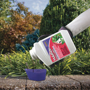 Malathion being poured into a cap
