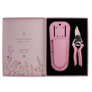 A pair of FELCO 6 Pink Blossom (Limited Edition) pruning shears and a matching leather holster set in an open presentation box featuring floral illustrations and brand text.