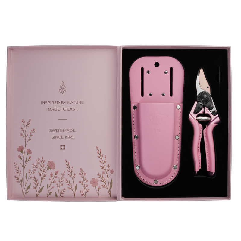 A pair of FELCO 6 Pink Blossom (Limited Edition) pruning shears and a matching leather holster set in an open presentation box featuring floral illustrations and brand text.