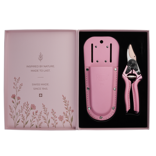 A pair of FELCO 6 Pink Blossom (Limited Edition) pruning shears and a matching leather holster set in an open presentation box featuring floral illustrations and brand text.