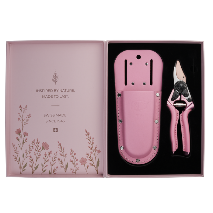 A pair of FELCO 6 Pink Blossom (Limited Edition) pruning shears and a matching leather holster set in an open presentation box featuring floral illustrations and brand text.