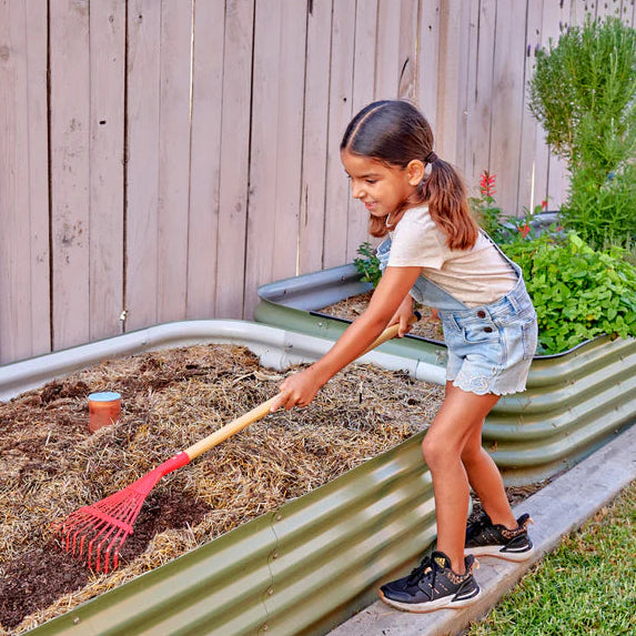 child using a red rake