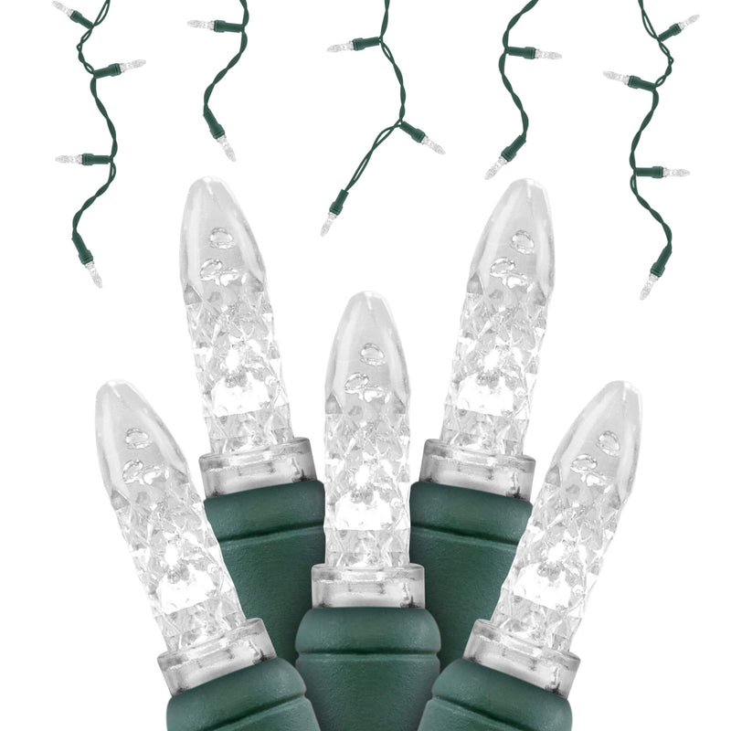 Close-up of five pure white LED Icicle String Lights (Green Wire), with additional strands in the classic icicle aesthetic hanging in the background.
